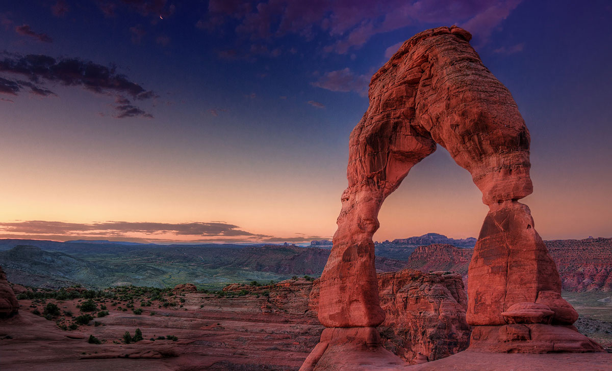 Delicate Arch silhouette at sunrise in Arches National Park